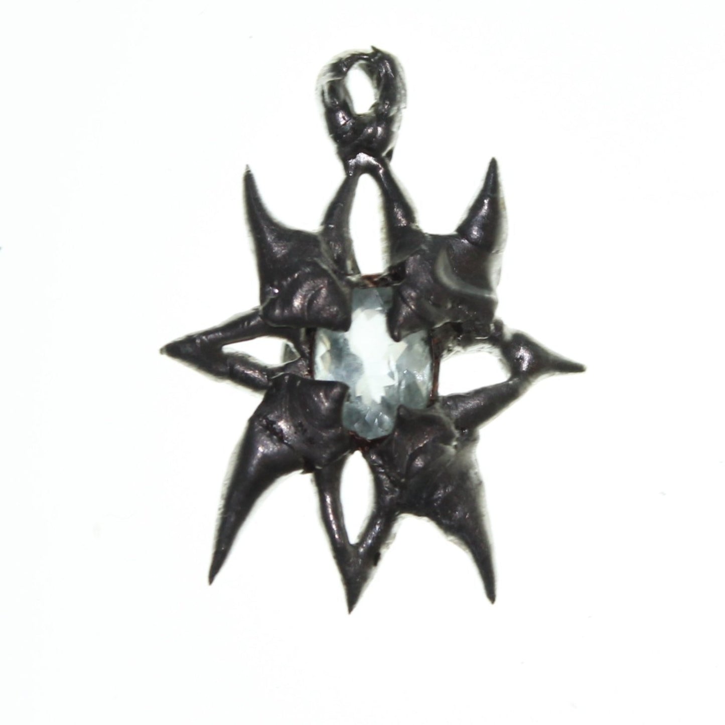 aquamarine soft soldered star amulet pendant on light background